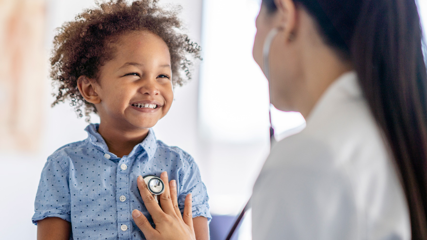 Child with provider getting a check up prior to receiving a flu vaccination