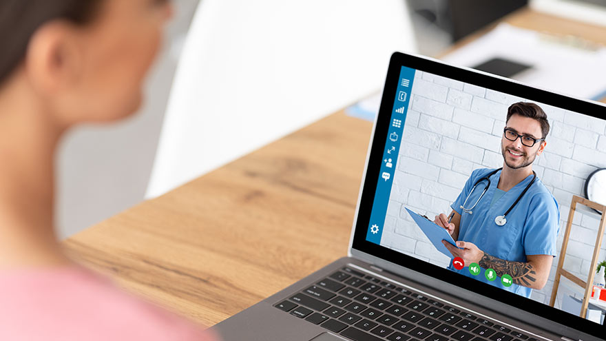 Woman making virtual visit appointment on laptop